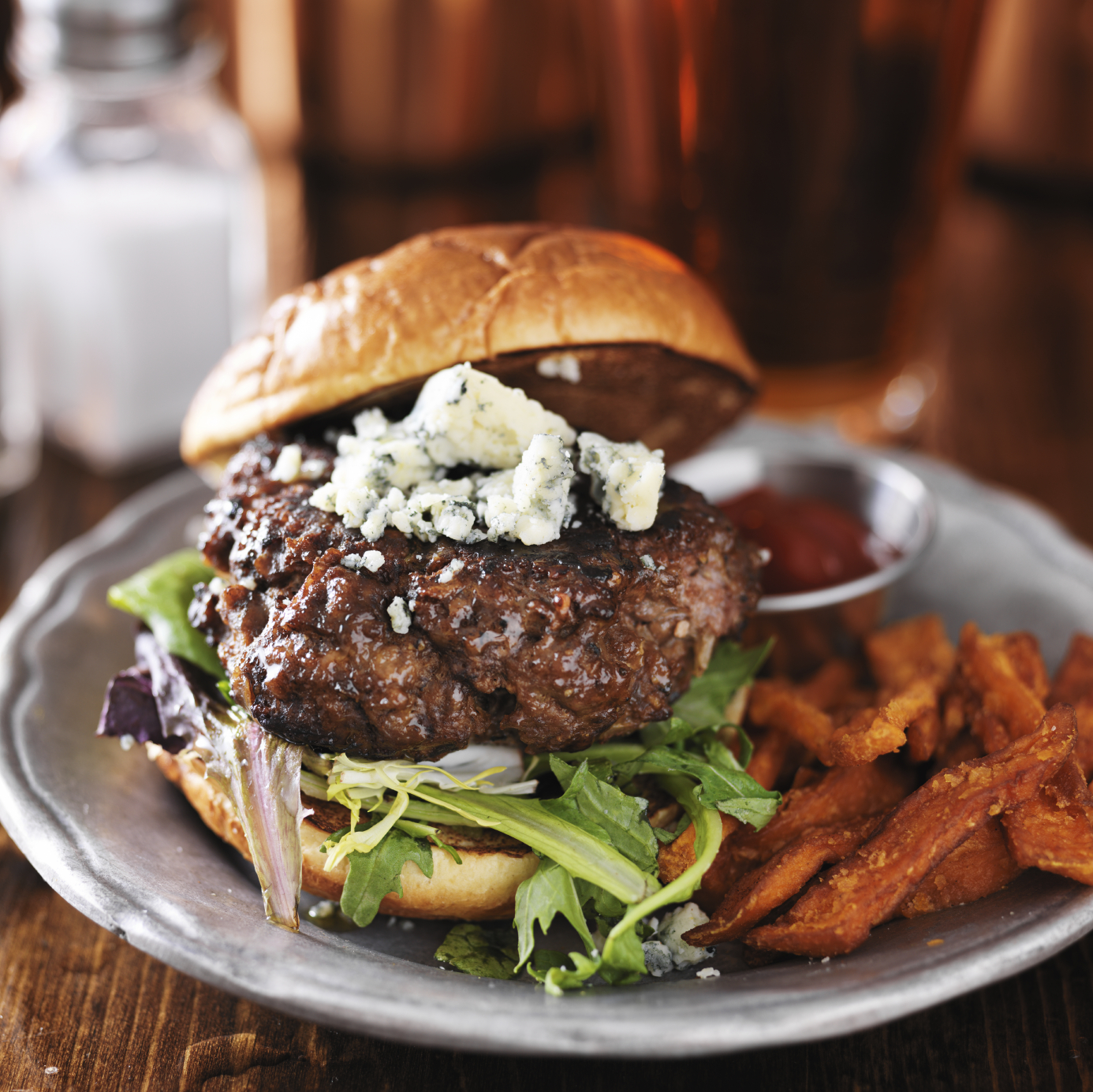 gourmet burger with blue cheese and sweet potato fries