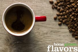 Cup of coffee and coffee beans viewed from directly above Cup of coffee and coffee beans on wooden textured laminate viewed from directly above. Photo is taken with dslr camera in studio.