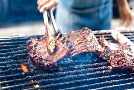Barbecue pork ribs-grilled. A close up photo of a chef hands grilled a barbeque pork ribs. The chef holding the ribs with a tongs. For more pictures like this https://secure.istockphoto.com/search/lightbox/15915184#14248356