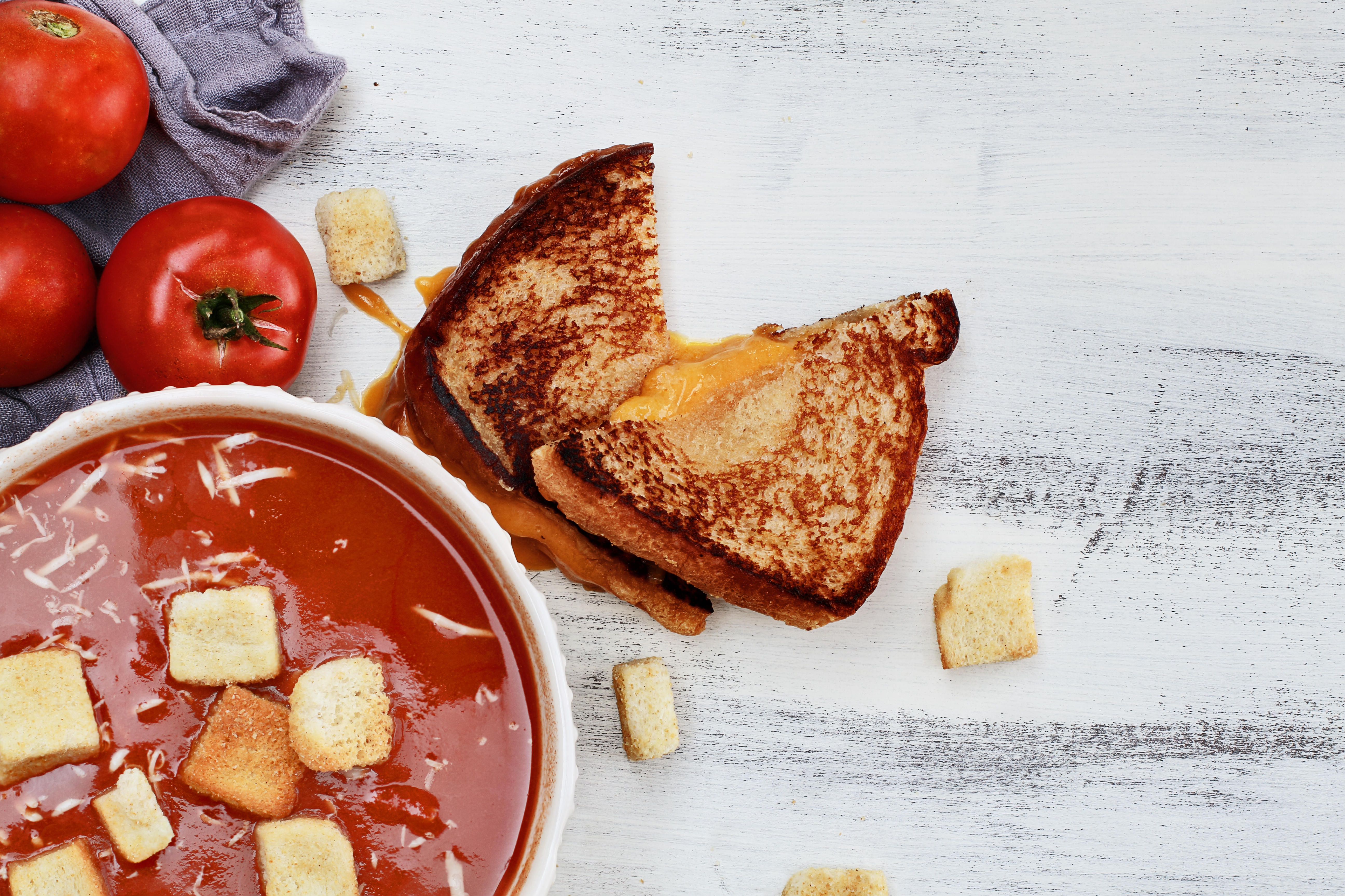 Tomato Soup garnished with Parmesan cheese and croutons
