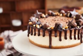 Delicious two-ply chocolate cheesecake decorated with candies and frosting