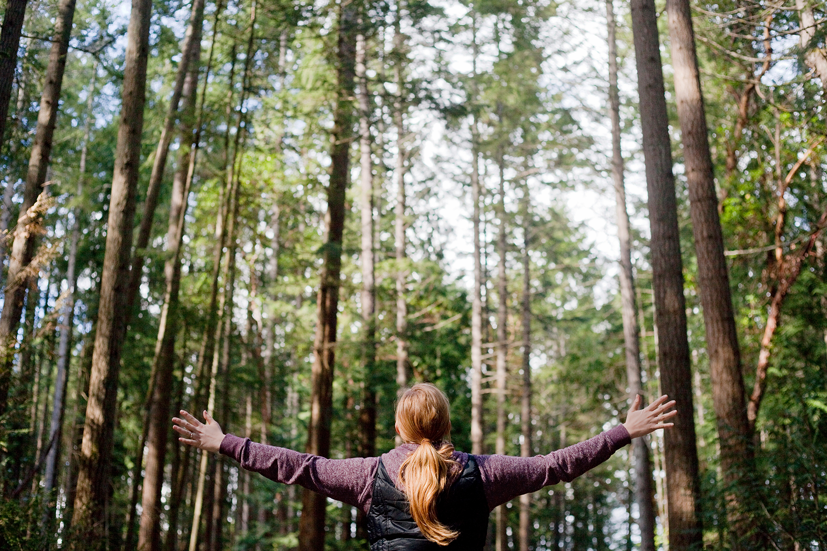 Woman with her arms open to Nature