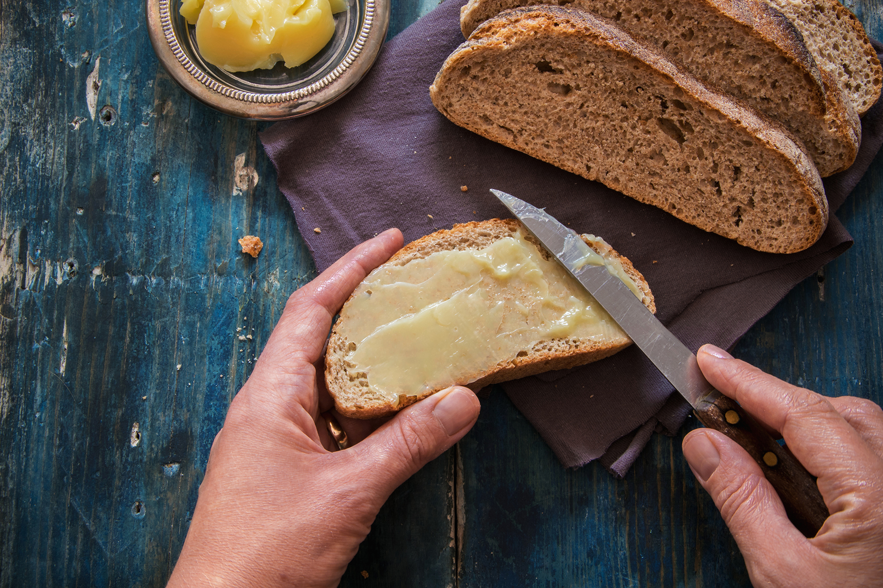 Spread fresh butter on whole wheat bread