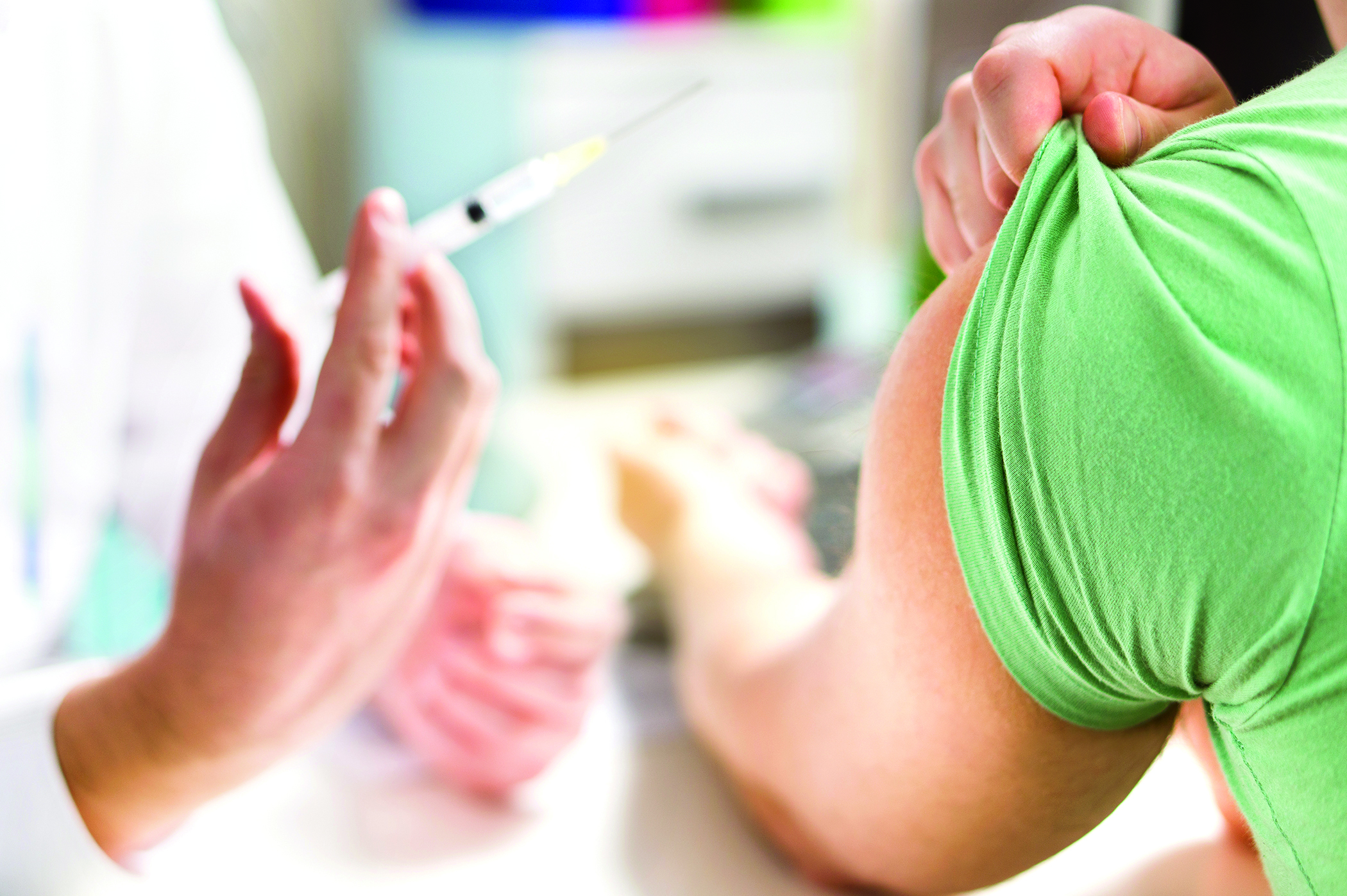 Doctor giving patient vaccine, flu or influenza shot or taking blood test with needle. Nurse with injection or syringe. Medicine, insulin or vaccination. Hospital office room.