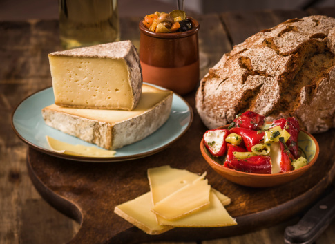 Antipasto with premium quality cheese, stuffed peppers, antipasto salad and white wine