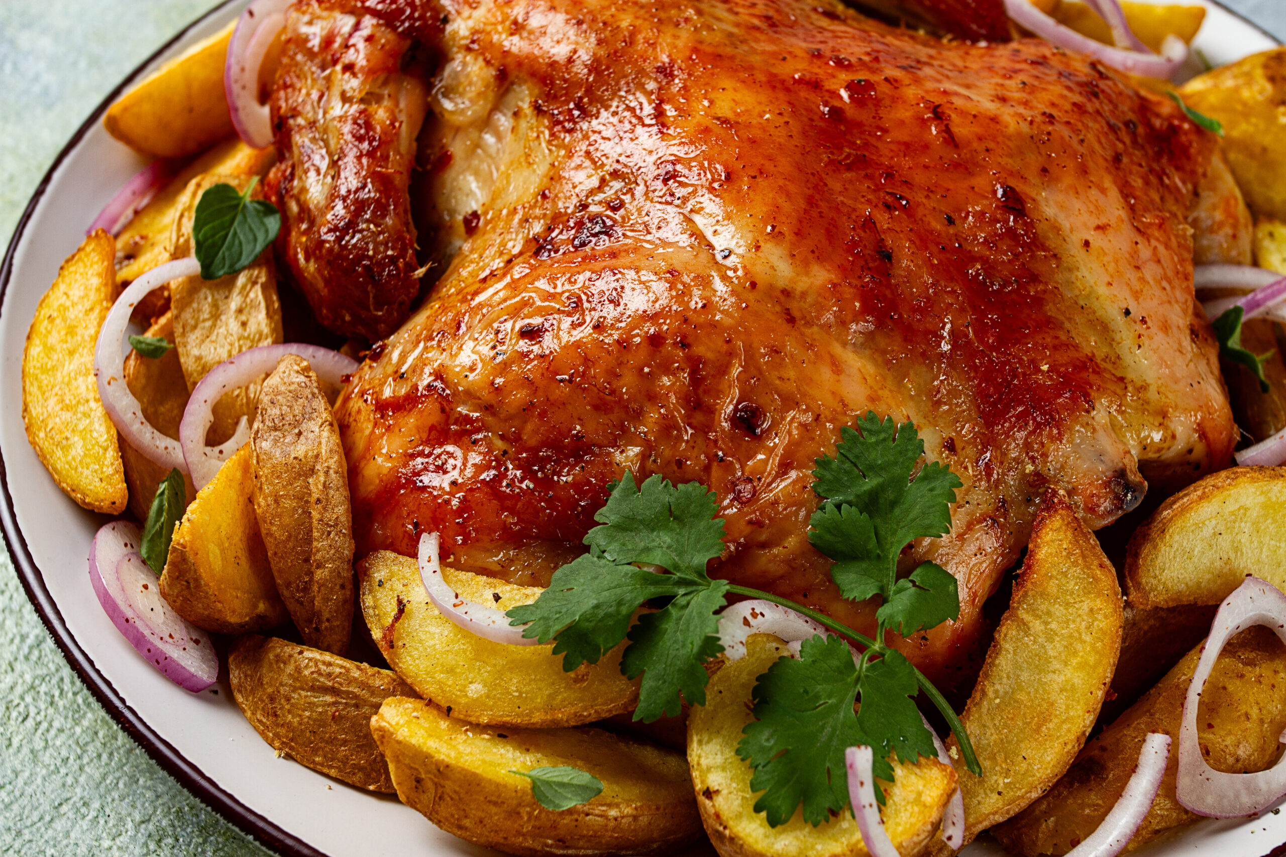 fried, baked chicken, in the oven, with spices, and rustic potatoes, top view, homemade,