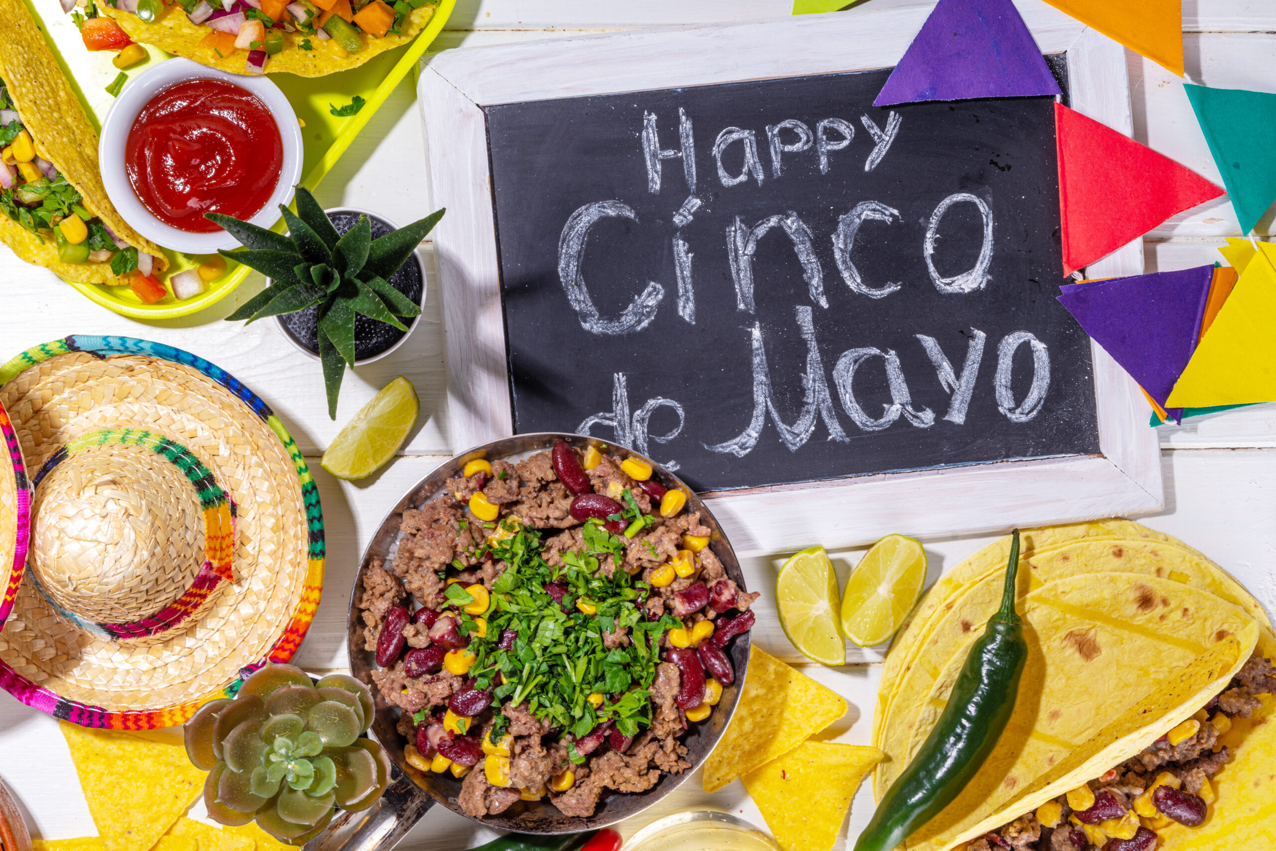 Cinco de Mayo party food Cinco de mayo party food. Mexican holiday Cinco de mayo traditional dishes, snacks, tortilla corn chips, nachos, tacos, salsa, sauces. Friends and family feast background top view copy space
