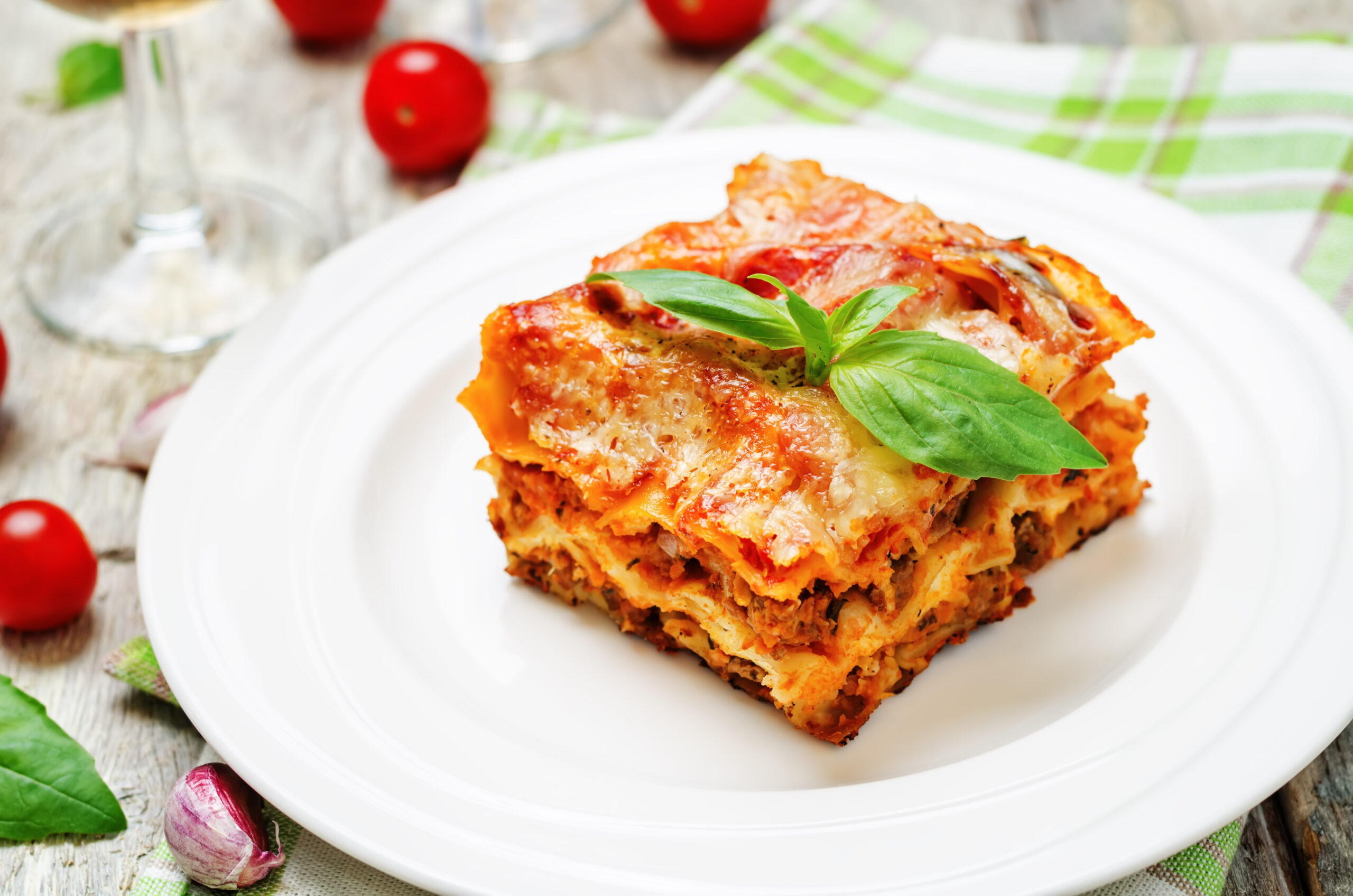 Meat lasagna Meat lasagna on a white wood background. toning. selective focus